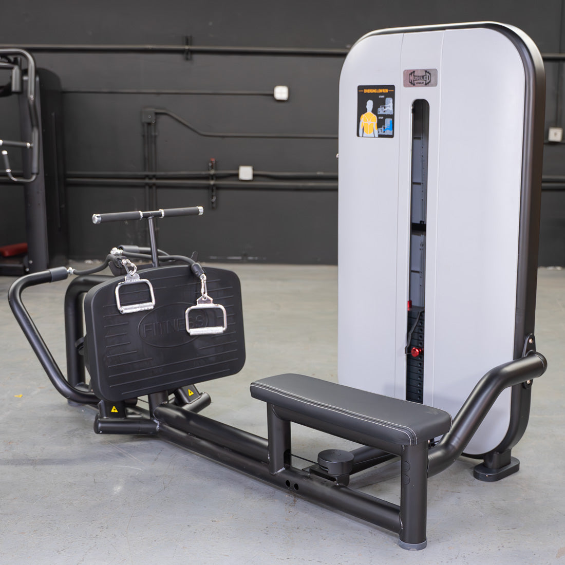 Black and white seated low row machine with pin selectorized weight stack and instruction diagram.