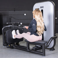 Thumbnail for Woman with long blonde hair using a seated low row machine in a gym.