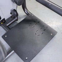 Thumbnail for Textured black footplate with four curved cutouts, part of a glute extension machine.