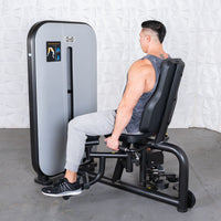 Thumbnail for Man using a gray and black inner/outer thigh workout machine with an adjustable seat.