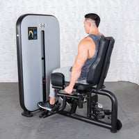 Thumbnail for Man using a gray and black inner/outer thigh workout machine.