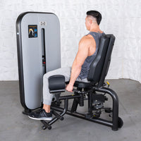 Thumbnail for Man seated on a black and gray inner/outer thigh workout machine.