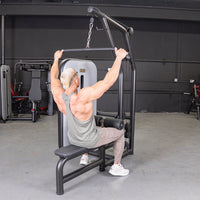 Thumbnail for Man using a black lat pulldown and low row machine with an adjustable seat and pin selectorized weights.