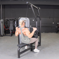 Thumbnail for Man using a black lat pulldown and low row combo machine with an adjustable seat.