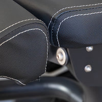 Thumbnail for Close-up of black textured upholstery with white stitching on fitness equipment.