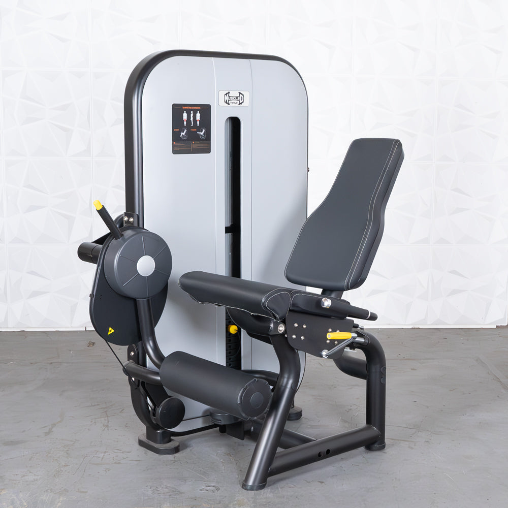Gray and black leg extension machine with adjustable seat and pin selectorized weight stack.
