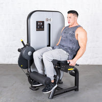 Thumbnail for Man using a gray and black leg extension machine with a pin selectorized weight stack.