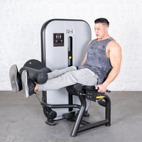 Thumbnail for Man using a leg extension machine, extending his legs forward.