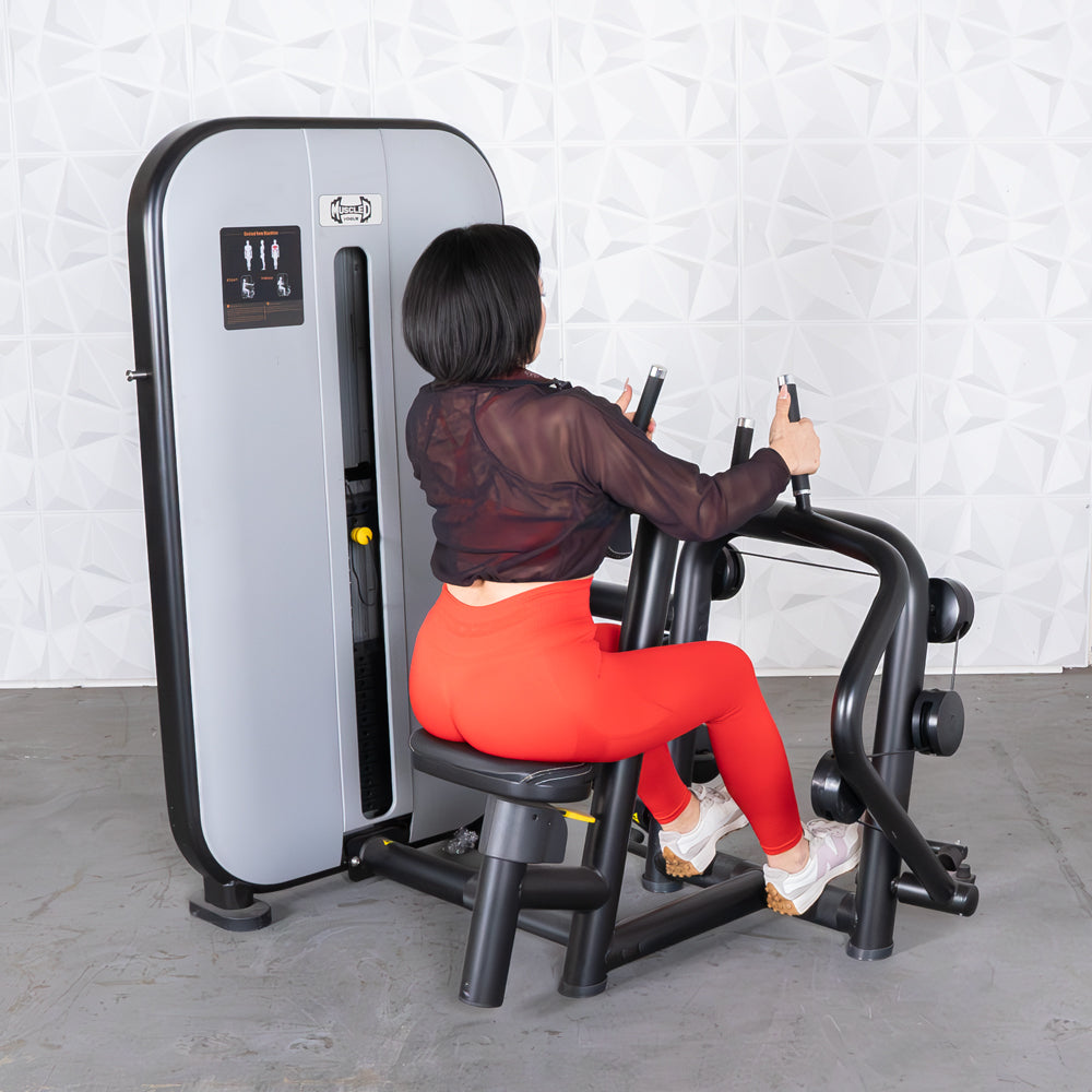 Woman in red leggings using a grey and black seated row machine.