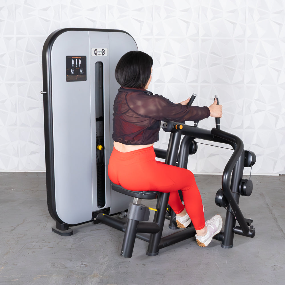 Woman in red leggings using a gray and black seated row machine.