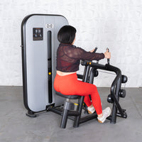 Thumbnail for Woman in red leggings using a gray and black seated row machine.