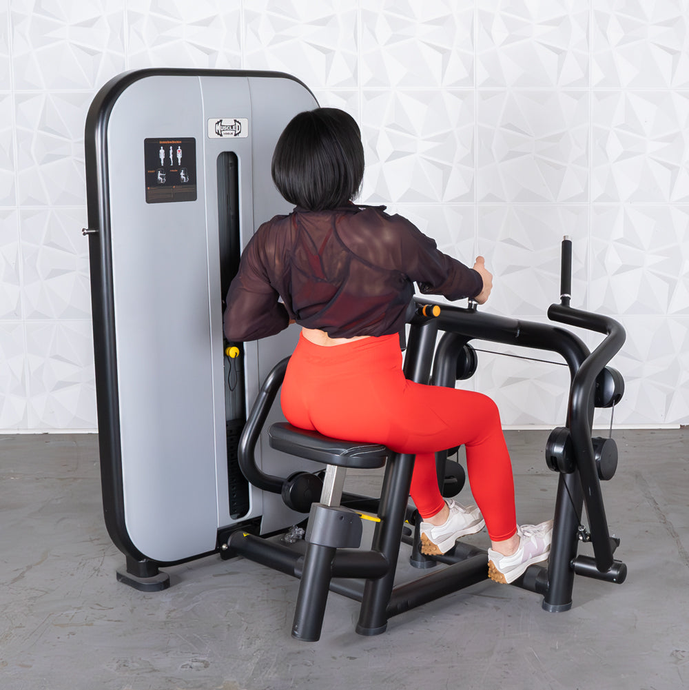 Woman in red leggings using a gray and black seated row machine.