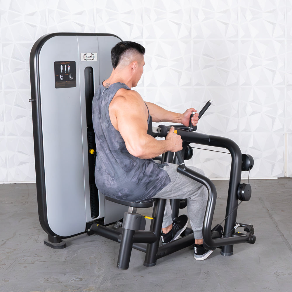 Man using a seated row machine with an adjustable seat and pin selectorized weight stack.