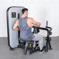 Thumbnail for Man in a tank top using a seated row machine with a gray weight stack.