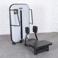 Thumbnail for Gray and black standing abductor machine with a weight stack and foot platform.