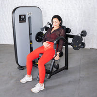 Thumbnail for Woman in red leggings using a gray and black triceps extension machine.