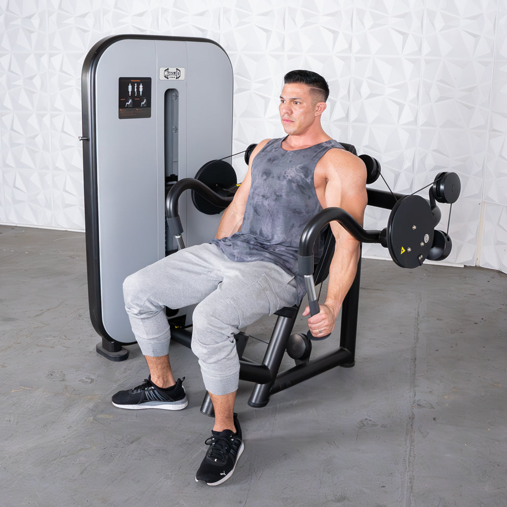 Man using a triceps extension machine with an adjustable seat and pin selectorized weights.