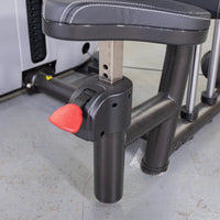 Thumbnail for Close-up of a black adjustable seat on a fitness machine, with a red lever and numbered height settings.