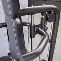 Thumbnail for Close-up of a triceps press-down machine with a black padded seat, black frame, and chrome adjustment bars.