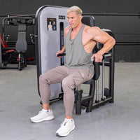Thumbnail for Man using a triceps press-down machine with an adjustable seat and pin selectorized weight stack.