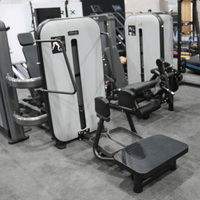 Thumbnail for Gray and black standing abductor machine with a weight stack and foot platforms in a gym setting.