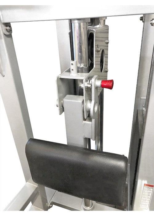 Close-up of the adjustable knee pad and selectorized weight stack mechanism on a chin-dip assist machine.