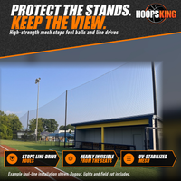 Thumbnail for Tall black backstop netting on poles running along the foul line of a turf baseball field beside a covered dugout