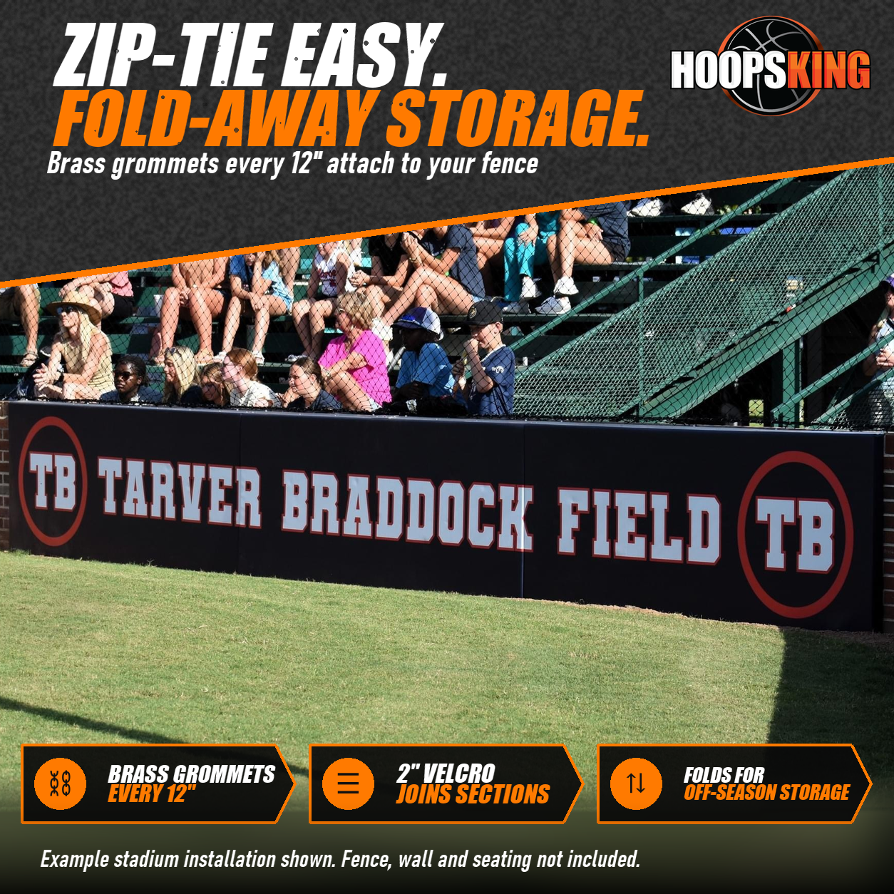 Black stadium wall padding printed with Tarver Braddock Field lettering and TB logos below fans in the bleachers
