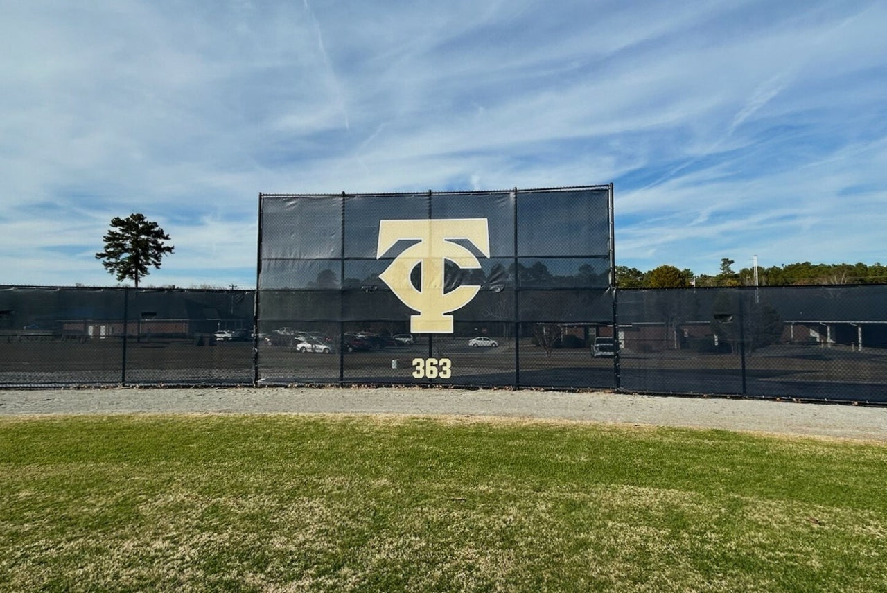 Custom printed FenceMate baseball batter's eye screen with team logo installed at Thomas County Central High School baseball field