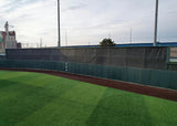 FenceMate baseball batter's eye screen with green outfield wall padding installed at University of Pennsylvania baseball field