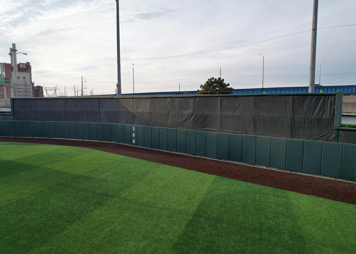 FenceMate baseball batter's eye screen with green outfield wall padding installed at University of Pennsylvania baseball field