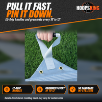 Thumbnail for Hand gripping the webbing pull handle of a silver FieldSaver infield tarp with two brass grommets on artificial turf