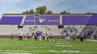 Thumbnail for Purple custom stadium seat covers with Holy Cross graphics covering bleacher seating sections
