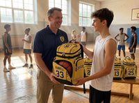 Thumbnail for Basketball coach handing a new custom team backpack to a player, more personalized bags on the bench