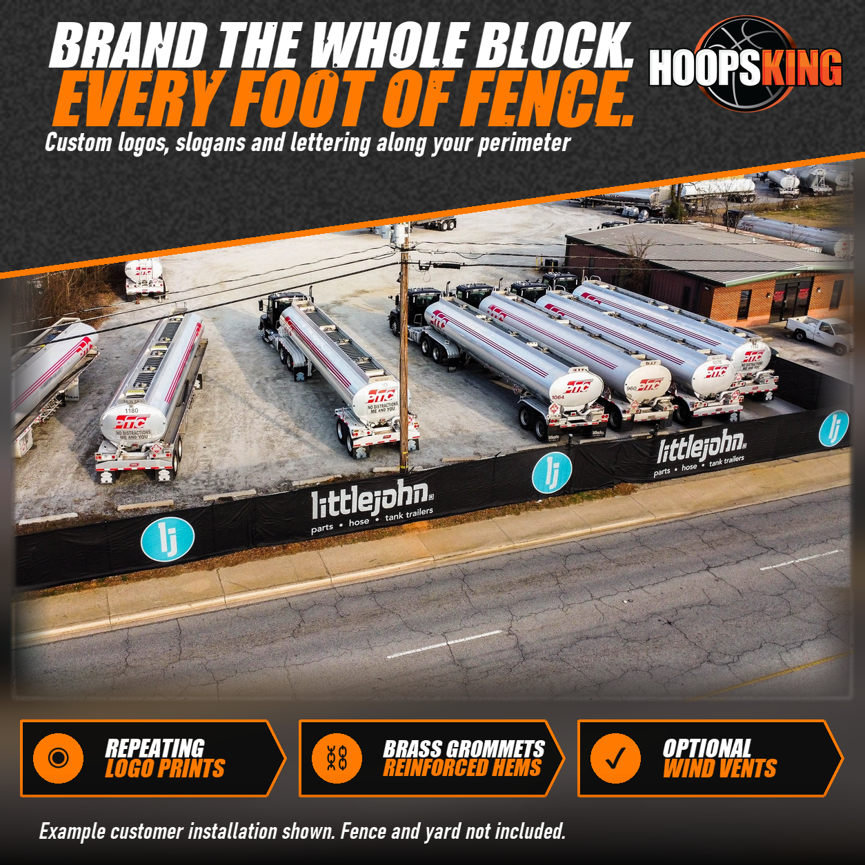 Aerial view of a black fence screen printed with Littlejohn logos along a roadside fence around a yard of tank trailers