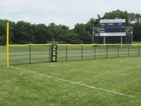 Thumbnail for Black outfield fence with a yellow top rail, yellow foul pole and green 200 marker by a Unionville High School scoreboard