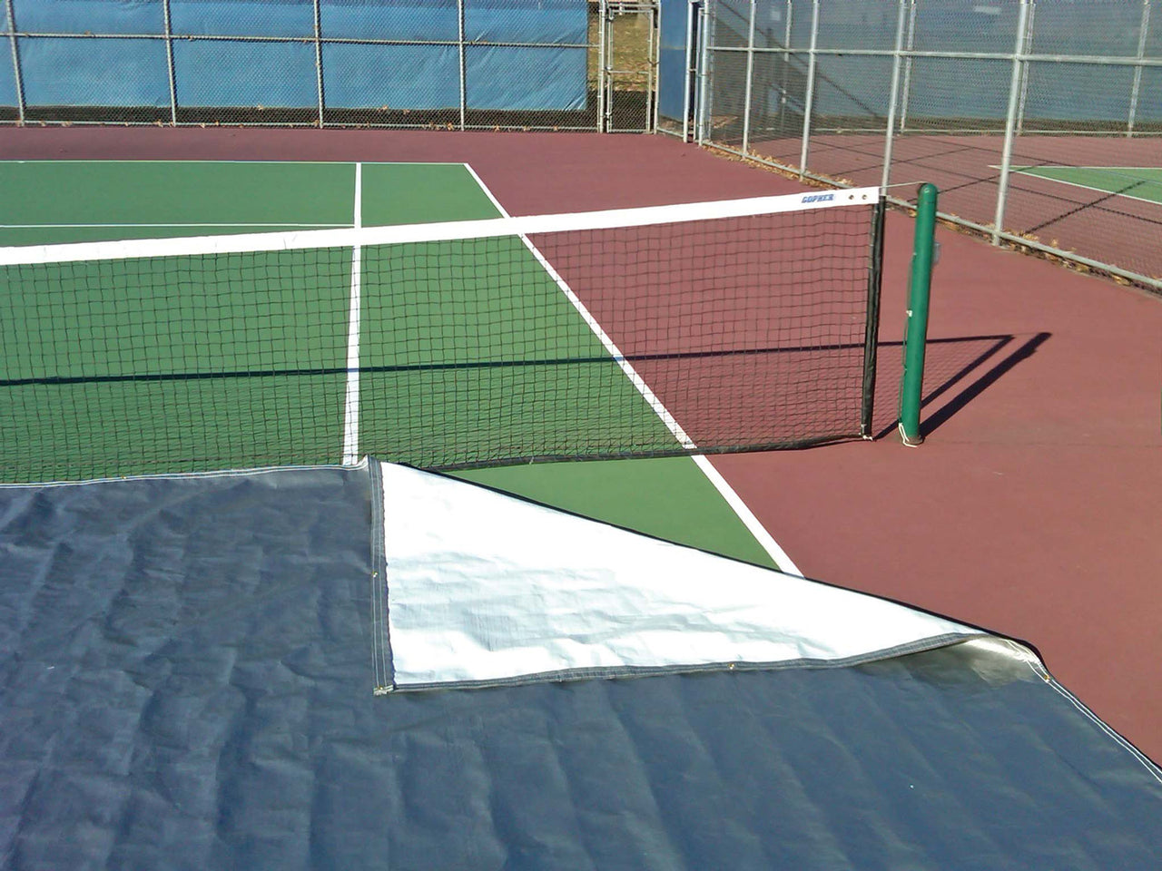 Tennis court cover folded back to show underside