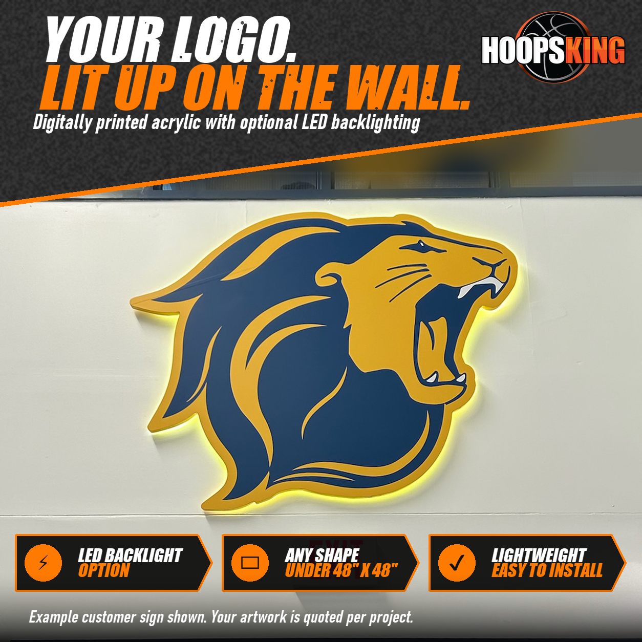 Backlit acrylic sign of a navy and gold roaring lion mascot mounted on a cream wall above an exit sign