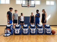 Thumbnail for Six custom basketball backpacks lined up on a gym floor, each personalized with a different player name and number