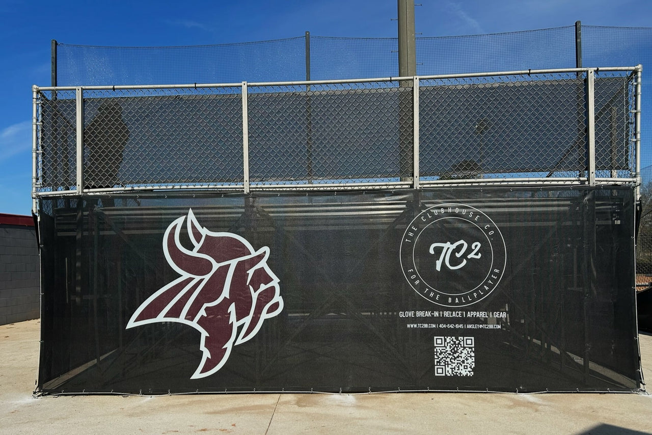 Custom printed bleacher enclosure featuring team mascot logo and sponsor graphics on black mesh at Northgate High School baseball field