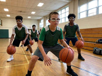 Thumbnail for Youth basketball player in dribble goggles pounding the ball low in a defensive stance with his eyes up