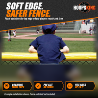 Thumbnail for Young fan in a navy cap leaning on yellow SafeFoam padding on top of a chain-link outfield fence during a game