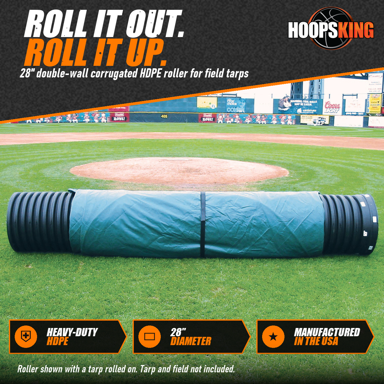 Black corrugated FieldSaver tarp roller with a green tarp rolled on it lying on the grass of a baseball field