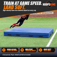 Thumbnail for Football receiver in a black and red uniform diving with the ball over a blue crash pad on a turf practice field