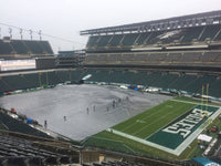 Thumbnail for Grounds crew pulling a large football field cover across the turf at Lincoln Financial Field, with the green Eagles end zone still exposed