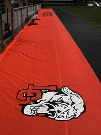 Thumbnail for Red football field sideline tarp with Lenoir City Panthers mascot logo protecting sideline area along track