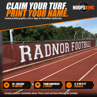 Thumbnail for Maroon fence windscreen printed with large white RADNOR FOOTBALL lettering along a chain-link fence beside a red running track