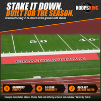 Thumbnail for Red sideline tarp printed with black Coatesville lettering on turf beside the 50 yard line and a running track