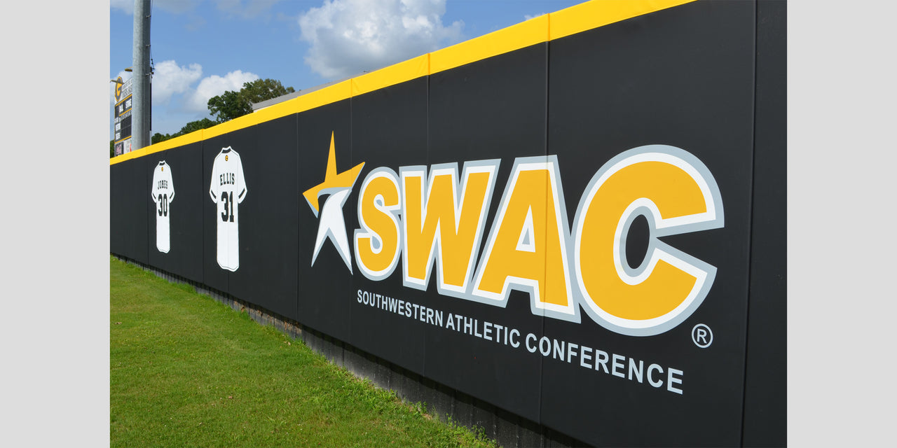 Black wall padding printed with a large SWAC conference logo and team jerseys