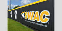 Thumbnail for Black wall padding printed with a large SWAC conference logo and team jerseys